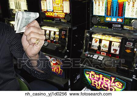Young man holding his winnings at the casino View Large Photo Image Stock Photograph - Young man holding his winnings at the casino. Fotosearch