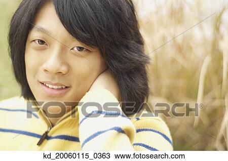 Stock Image - Young man posing for the camera. Fotosearch