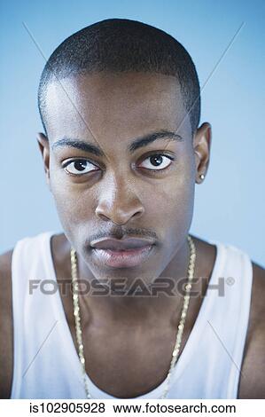 Young man posing for the camera View Large Photo Image Stock Photo - Young man posing for the camera. Fotosearch