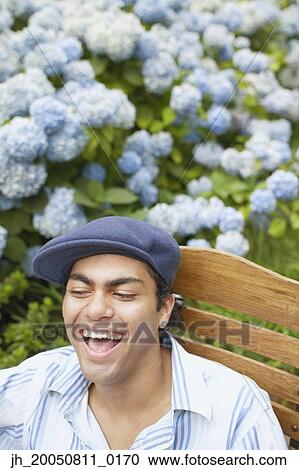 Young man relaxing in a lawn chair View Large Photo Image Stock Image - Young man relaxing in a lawn chair. Fotosearch