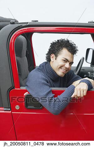 Young man riding in a car View Large Photo Image Stock Photo - Young man riding in a car. Fotosearch