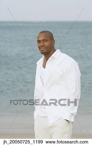 Young man smiling for the camera View Large Photo Image Stock Photo - Young man smiling for the camera. Fotosearch