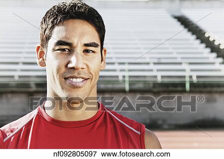 Young man smiling for the camera View Large Photo Image Stock Photo - Young man smiling for the camera. Fotosearch
