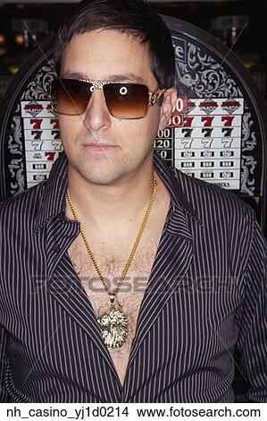 Young man wearing a pendant and sunglasses View Large Photo Image Picture - Young man wearing a pendant and sunglasses. Fotosearch