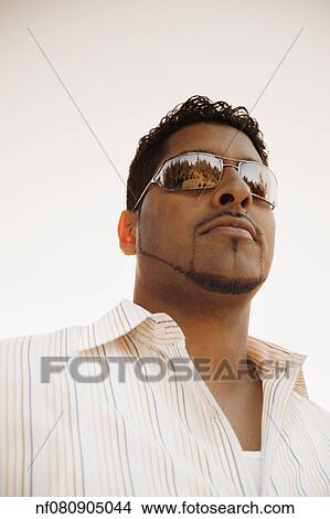 Young man wearing sunglasses View Large Photo Image Picture - Young man wearing sunglasses. Fotosearch