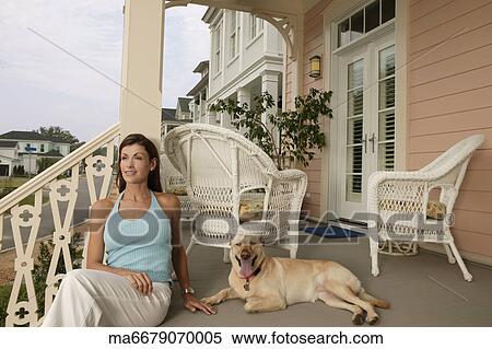 Young woman and her dog on their porch View Large Photo Image Stock Photography - Young woman and her dog on their porch. Fotosearch