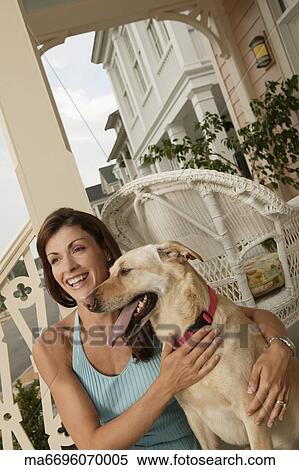 Young woman and her dog on their porch View Large Photo Image Stock Photography - Young woman and her dog on their porch. Fotosearch