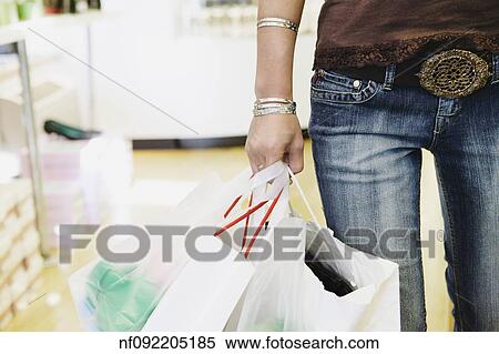 Young woman carrying shopping bags View Large Photo Image Stock Photography - Young woman carrying shopping bags. Fotosearch