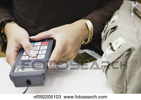 Young woman entering her PIN View Large Photo Image Stock Image - Young woman entering her PIN. Fotosearch