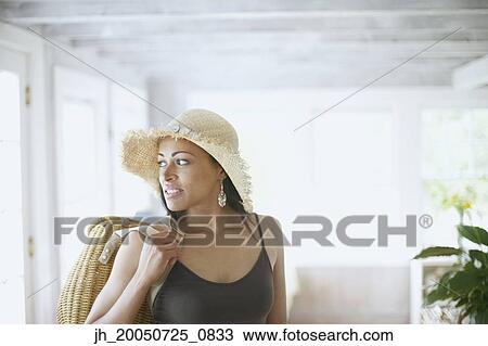 Stock Image - Young woman holding a purse. Fotosearch