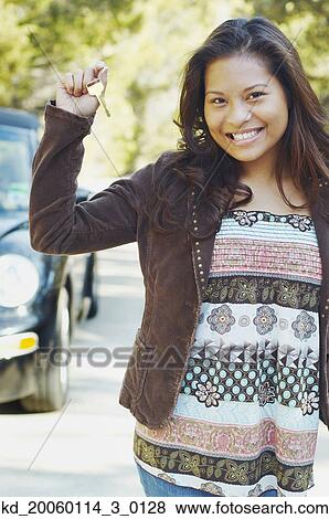 Stock Photo - Young woman holding car keys. Fotosearch