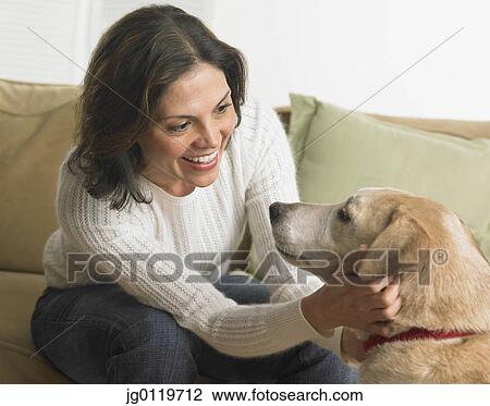 Young woman petting her dog View Large Photo Image Stock Image - Young woman petting her dog. Fotosearch