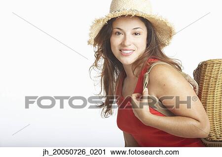 Young woman posing for the camera in a straw hat View Large Photo Image Stock Image - Young woman posing for the camera in a straw hat. Fotosearch