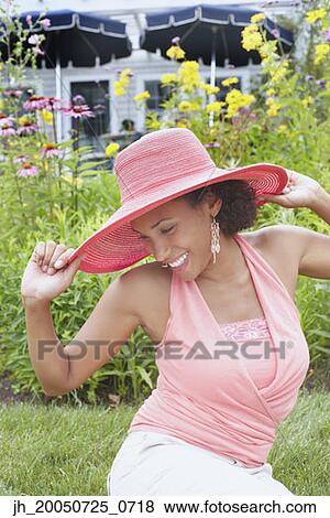 Young woman posing for the camera in a straw hat View Large Photo Image Stock Photo - Young woman posing for the camera in a straw hat. Fotosearch