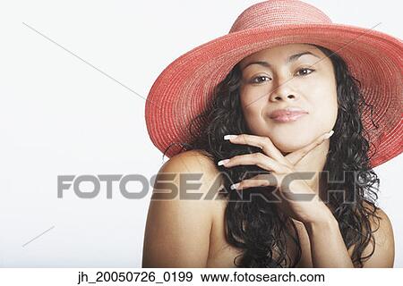 Young woman posing for the camera in a straw hat View Large Photo Image Stock Photo - Young woman posing for the camera in a straw hat. Fotosearch