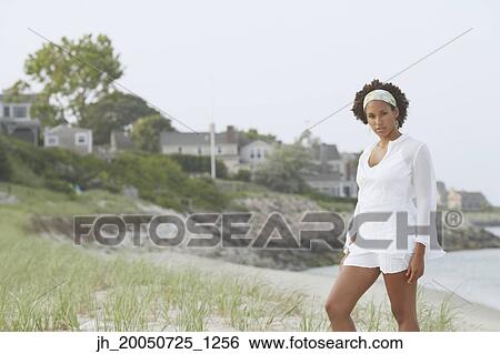 Young woman posing for the camera View Large Photo Image Stock Photograph - Young woman posing for the camera. Fotosearch