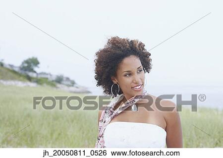 Young woman posing for the camera View Large Photo Image Stock Photograph - Young woman posing for the camera. Fotosearch