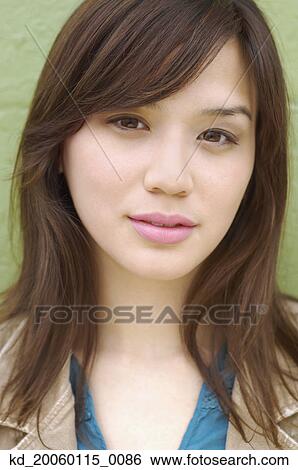Stock Photograph - Young woman posing for the camera. Fotosearch