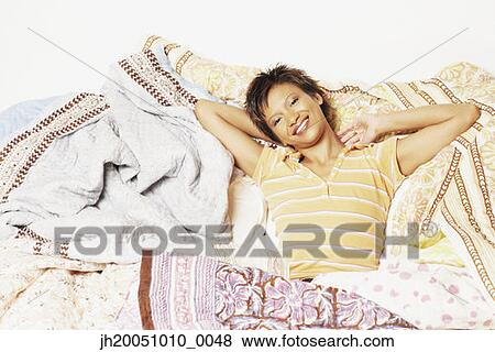 Young woman relaxing among blankets View Large Photo Image Stock Photo - Young woman relaxing among blankets. Fotosearch
