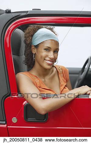 Young woman riding in a car View Large Photo Image Stock Photo - Young woman riding in a car. Fotosearch
