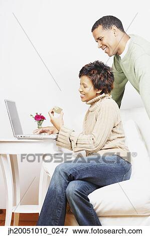 Young woman shopping over the Internet View Large Photo Image Stock Photo - Young woman shopping over the Internet. Fotosearch