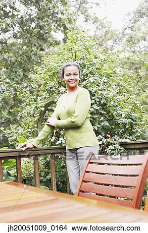 Young woman smiling for the camera outdoors View Large Photo Image Picture - Young woman smiling for the camera outdoors. Fotosearch