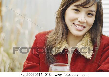 Picture - Young woman smiling for the camera. Fotosearch
