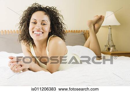 Young woman smiling for the camera View Large Photo Image Stock Image - Young woman smiling for the camera. Fotosearch