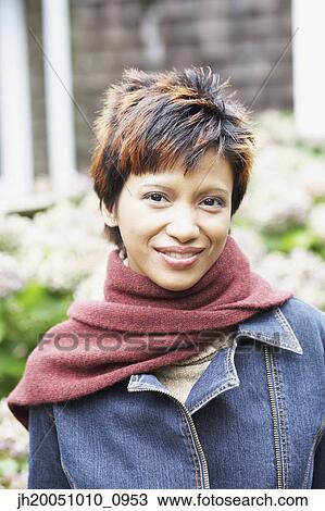 Young woman smiling for the camera outdoors View Large Photo Image Stock Image - Young woman smiling for the camera outdoors. Fotosearch