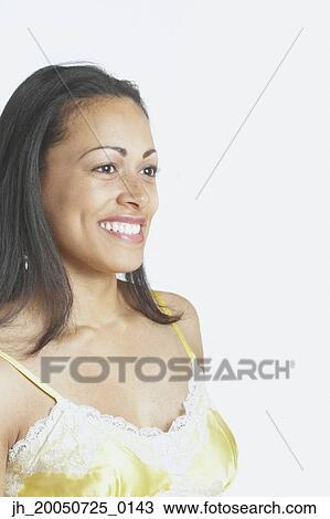 Stock Image - Young woman smiling for the camera. Fotosearch