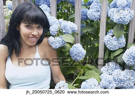 Young woman smiling for the camera View Large Photo Image Stock Image - Young woman smiling for the camera. Fotosearch