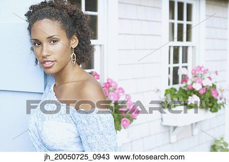 Young woman smiling for the camera View Large Photo Image Stock Image - Young woman smiling for the camera. Fotosearch