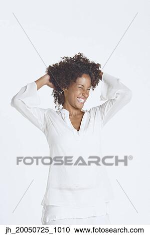 Stock Image - Young woman smiling for the camera. Fotosearch