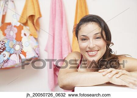 Young woman smiling for the camera View Large Photo Image Stock Image - Young woman smiling for the camera. Fotosearch