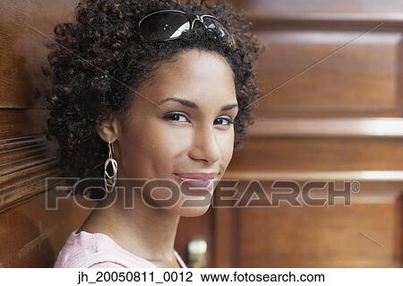 Young woman smiling for the camera View Large Photo Image Stock Image - Young woman smiling for the camera. Fotosearch