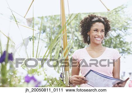 Young woman smiling for the camera View Large Photo Image Stock Image - Young woman smiling for the camera. Fotosearch