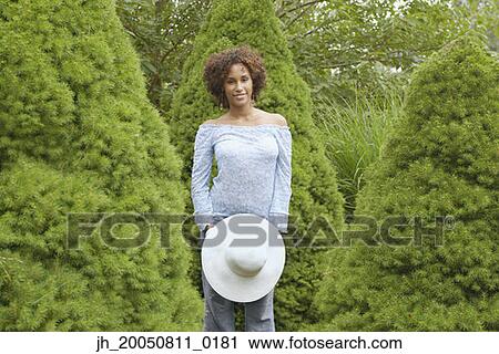 Stock Image - Young woman smiling for the camera. Fotosearch