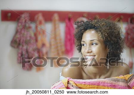 Young woman smiling for the camera View Large Photo Image Stock Image - Young woman smiling for the camera. Fotosearch