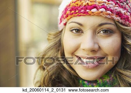 Stock Image - Young woman smiling for the camera. Fotosearch