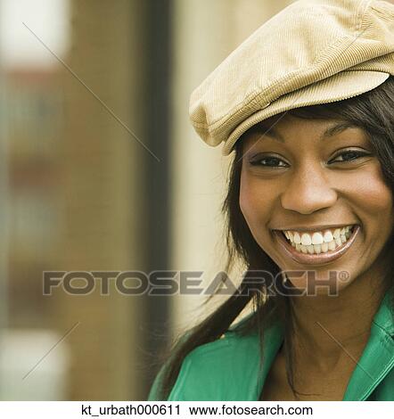 Young woman smiling for the camera View Large Photo Image Stock Image - Young woman smiling for the camera. Fotosearch