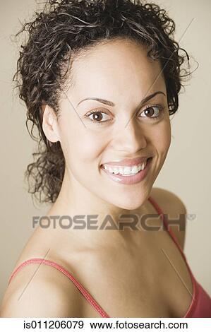 Young woman smiling for the camera View Large Photo Image Stock Photo - Young woman smiling for the camera. Fotosearch