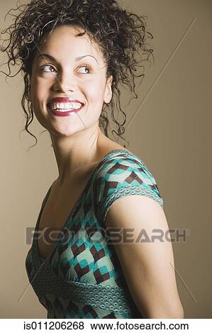 Young woman smiling for the camera View Large Photo Image Stock Photo - Young woman smiling for the camera. Fotosearch