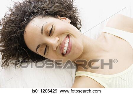 Stock Photo - Young woman smiling for the camera. Fotosearch