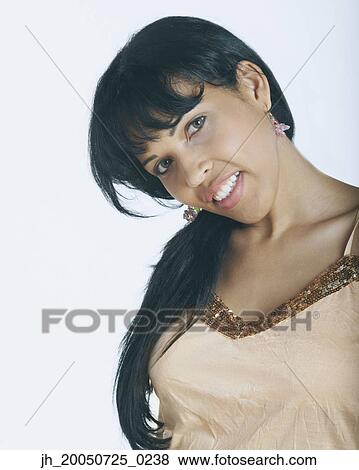 Young woman smiling for the camera View Large Photo Image Stock Photo - Young woman smiling for the camera. Fotosearch