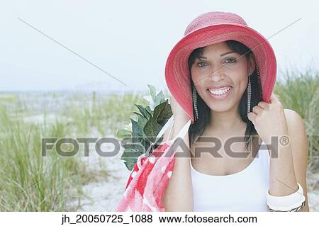 Young woman smiling for the camera View Large Photo Image Stock Photo - Young woman smiling for the camera. Fotosearch