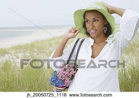 Stock Photo - Young woman smiling for the camera. Fotosearch