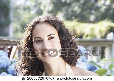 Young woman smiling for the camera View Large Photo Image Stock Photo - Young woman smiling for the camera. Fotosearch