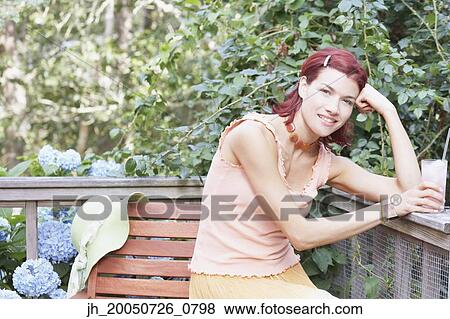 Young woman smiling for the camera View Large Photo Image Stock Photo - Young woman smiling for the camera. Fotosearch