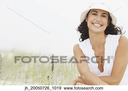 Young woman smiling for the camera View Large Photo Image Stock Photo - Young woman smiling for the camera. Fotosearch