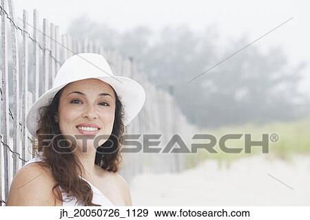 Young woman smiling for the camera View Large Photo Image Stock Photo - Young woman smiling for the camera. Fotosearch